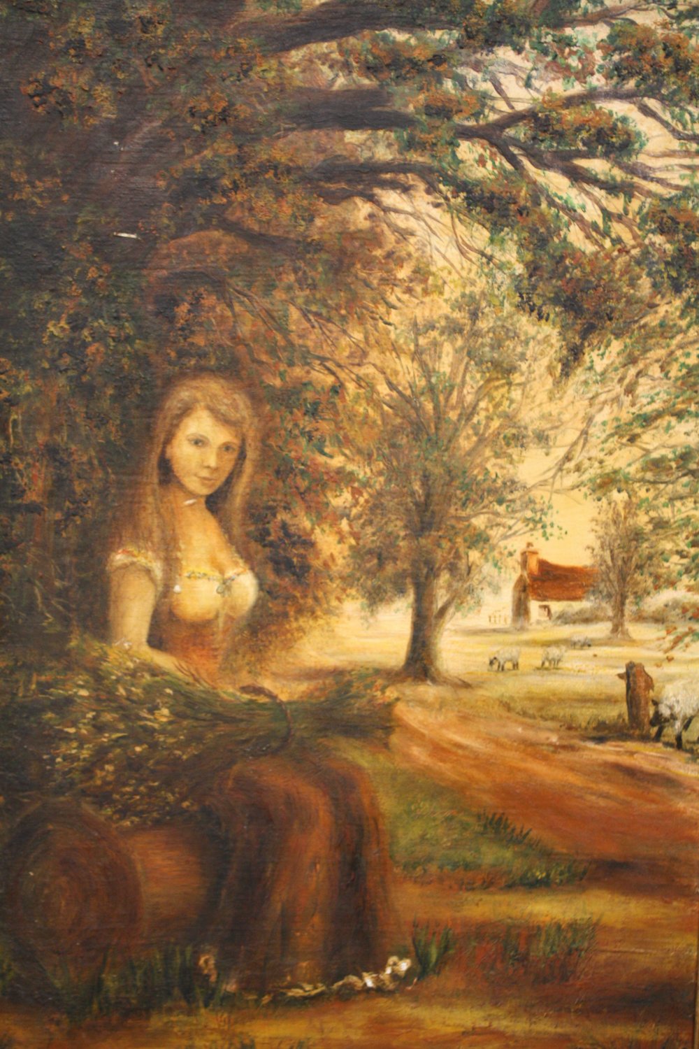 A GILT FRAMED OIL ON BOARD OF A WOODED LANDSCAPE WITH A WOMAN HOLDING A SHEATH OF CORN, SIZE 60 CM X