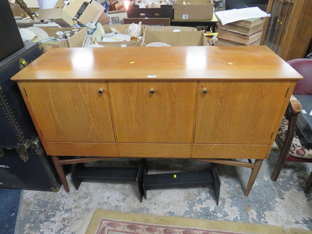 A RETRO TEAK SIDEBOARD WITH THREE CUPBOARDS ABOVE DRAWERS RAISED ON CYLINDRICAL LEGS H-94.5 W-140