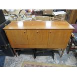 A RETRO TEAK SIDEBOARD WITH THREE CUPBOARDS ABOVE DRAWERS RAISED ON CYLINDRICAL LEGS H-94.5 W-140