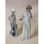 TWO NAO FIGURES OF A GIRL WITH A CHAMBER STICK AND A BOY WITH A DOG, WITHOUT MODEL NUMBERS