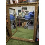 A LARGE REPRODUCTION GILT FRAMED MIRROR