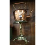 A COPPER KETTLE ON BRASS STAND