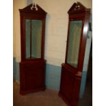 TWO MATCHING YEW LOCKING CORNER DISPLAY UNITS WITH LIGHTS AND SERPENTINE FRONT SHELF