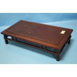 A CHINESE HARDWOOD SCHOLAR'S TABLE TOP LOW STAND RAISED ON FOUR LEGS