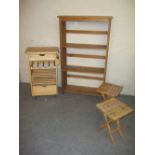 A KITCHEN WORK STATION TABLE, TWO FOLDING TABLES / STOOLS AND A PINK BOOKSHELF