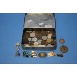 A TIN OF ASSORTED COINS AND BADGES