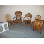 AN OAK SWIVEL OFFICE CHAIR, A REPRODUCTION BEDROOM CHAIR, TWO PINE DINING CHAIRS, A PINE WALL