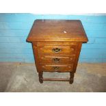 AN OAK MINIATURE THREE DRAWER CHEST