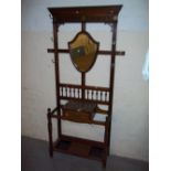 AN EDWARDIAN HALL COAT STAND WITH MARBLE SHELF AND BEVELL EDGED SHIELD MIRROR