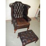 A BROWN LEATHER QUEEN ANNE STYLED CHESTERFIELD CHAIR AND FOOT STOOL