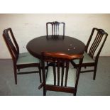 A STAG MAHOGANY EXTENDING DINING TABLE SET WITH FOUR CHAIRS