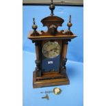 AN ANTIQUE WALNUT CASED MANTEL CLOCK