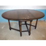 AN OAK DROP LEAF DINING TABLE