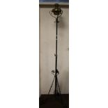 A VINTAGE TALL CAST AND BRASS OIL LAMP ON TRIPOD BASE