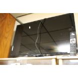 AN HITACHI 33" FLATSCREEN TV AND REMOTE CONTROL