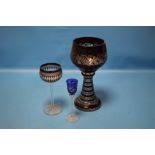 A LARGE BOHEMIAN RUBY OVERLAY GLASS GOBLET WITH GRAPE AND VINE DECORATION TOGETHER WITH TWO OTHER