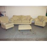 A RETRO STYLED FABRIC FOUR PIECE SUITE WITH FOOTSTOOL AND THREE SEATER SOFA