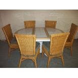 AN EXTENDING TILE TOPPED ROUND DINING SET TABLE AND SIX WICKER CHAIRS