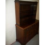 AN OAK DRESSER WITH CARVED DETAILING