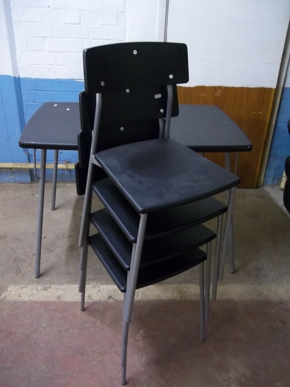 A BLACK DINING TABLE AND FOUR STACKABLE CHAIRS - Image 2 of 2