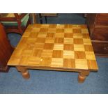 AN UNUSUAL LOW OAK COFFEE TABLE WITH APPLIED PARQUET STYLE TILES - SOME LOOSE H-38 W-84 CM