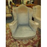 A VINTAGE WING-BACK ARMCHAIR WITH HAIRY PAW FEET A/F