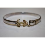 A WHITE AND YELLOW METAL BANGLE STAMPED STERLING 14K WITH ANCHOR SHAPED CLASP APPROX WEIGHT - 15.3G