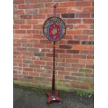 AN ANTIQUE MAHOGANY POLE SCREEN WITH CIRCULAR BEADWORK PANEL