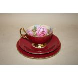 AN AYNSLEY CABBAGE ROSE PATTERN CUP, SAUCER AND SIDEPLATE TRIO