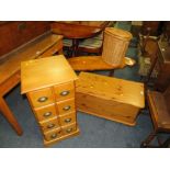 A HONEY PINE BLANKET BOX, SET OF DRAWERS, WICKER BASKET AND COFFEE TABLE (4)