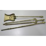 A VINTAGE BRASS THREE PIECE FIRESIDE COMPANION SET