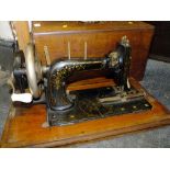 AN INLAID MAHOGANY CASED ANTIQUE FRISTER AND ROSSMANN SEWING MACHINE