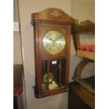 A VINTAGE OAK CASED WALLCLOCK