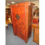 A CHINESE TWO DOOR LACQUERED CUPBOARD WITH RED PAINTED DETAIL H-177 W-107 CM