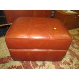 A MODERN TAN LEATHER FOOTSTOOL