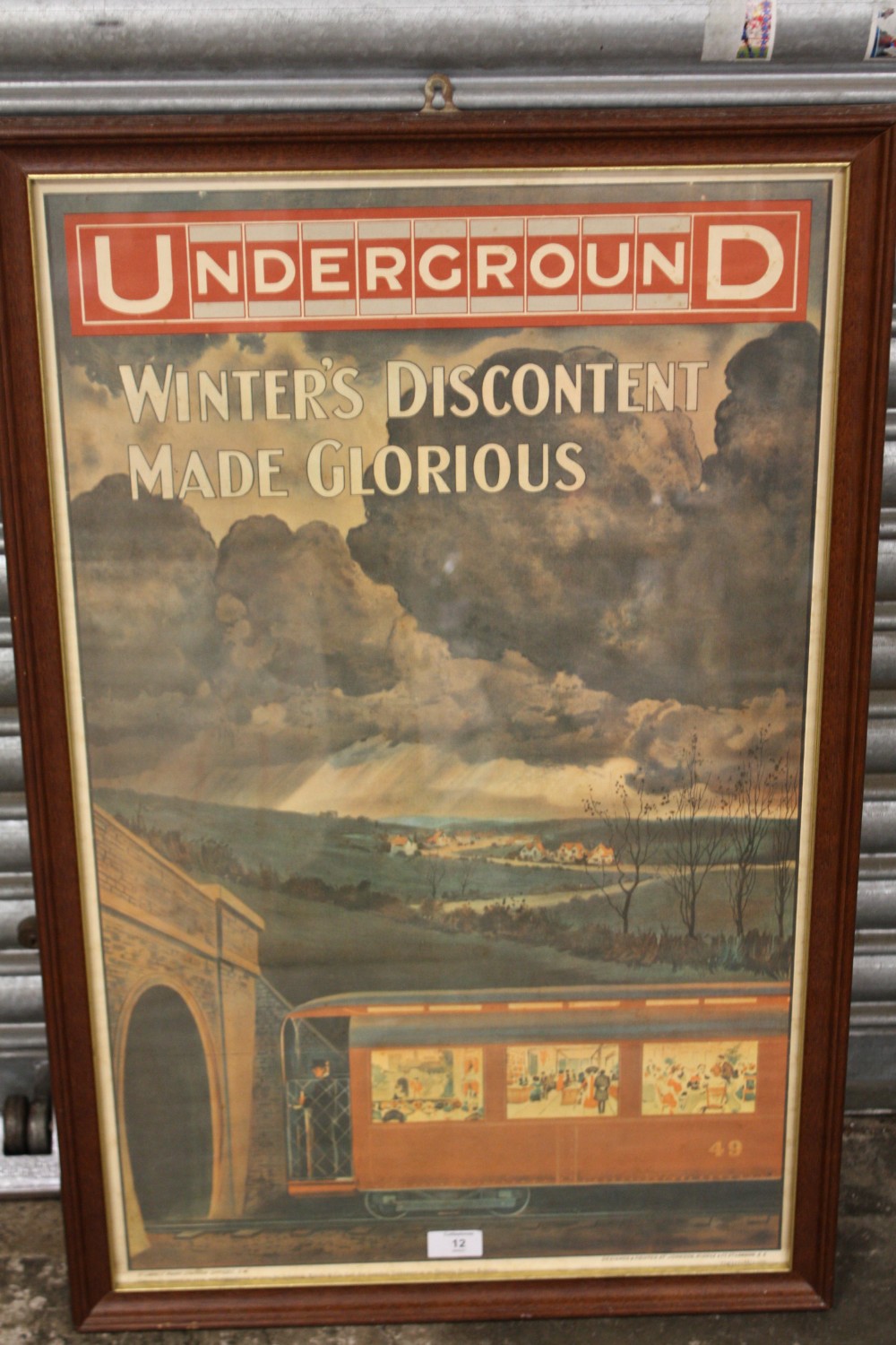 A REPRODUCTION FRAMED AND GLAZED LONDON RAILWAY INTEREST PRINT ENTITLED 'UNDERGROUND WINTERS