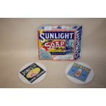 A REPRODUCTION ENAMEL ADVERTISING SIGN FOR SUNLIGHT SOAP TOGETHER WITH TWO CERAMIC ADVERTISING