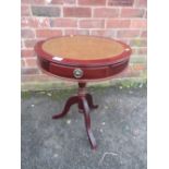 A SMALL REPRODUCTION DRUM STYLE OCCASIONAL TABLE