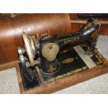 A CASED VINTAGE SINGER SEWING MACHINE