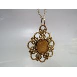 A 1945 DOS PESOS GOLD COIN PENDANT ON CHAIN, the gold coin mounted in a 9ct gold pendant suspended