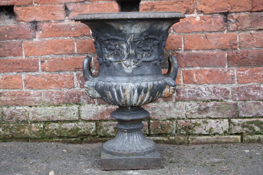 A VICTORIAN STYLE CAST IRON CAMPANA SHAPED GARDEN URN, with twin handles and foliate detail, H 83