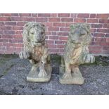 A PAIR OF CAST STONE LION GARDEN FIGURES, with raised paw, bearing makers stamp to base, H 62 cm, D