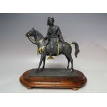 A 20TH CENTURY LEAD FIGURE OF AN ARAB ON HORSEBACK, with gilded embellishment, having a blued