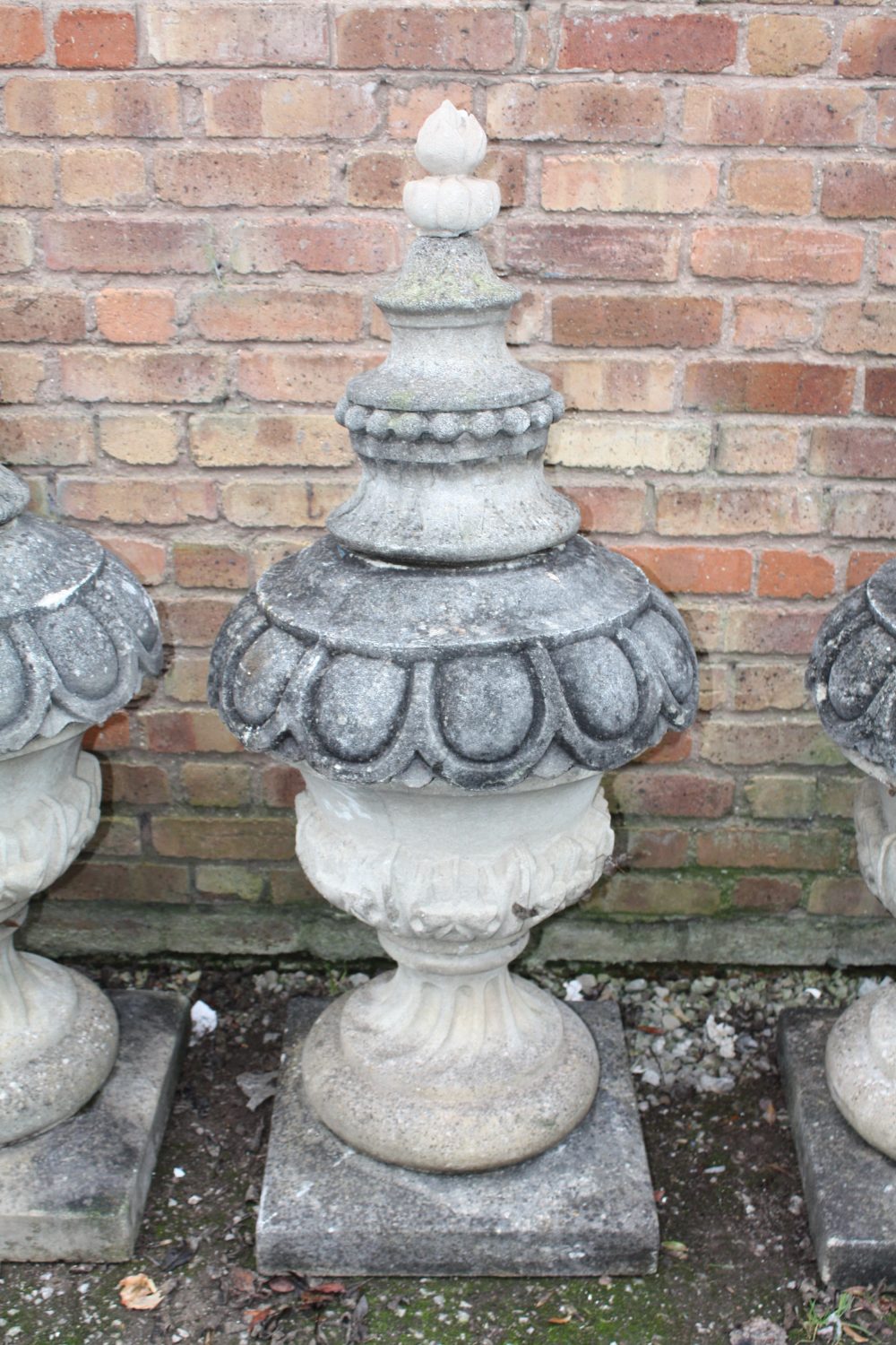 A PAIR OF LARGE STONE PEDESTAL URNS, supported on a squared foot leading to a solid swirling base, - Image 2 of 3