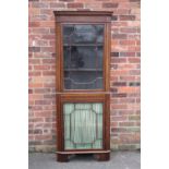AN ANTIQUE MAHOGANY AND INLAID FLOOR STANDING CORNER CABINET, having two astragel glazed doors, H