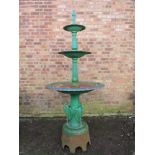 A CAST IRON THREE TIER FOUNTAIN, raised on a plinth decorated with three heron type birds, overall H
