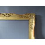 A LATE 19TH / EARLY 20TH CENTURY GOLD SWEPT FRAME, frame W 8 cm, frame rebate 68.5 x 52.5 cm