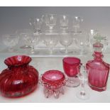 FOUR ITEMS OF VICTORIAN CRANBERRY GLASSWARE, to include a faceted glass bottle with stopper,