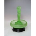 A WALTHER & SOHNE STYLE URANIUM GLASS FIGURAL CENTREPIECE, raised on an associated black glass