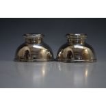 A PAIR OF UNUSUAL DOME SHAPED CAPSTAN TYPE HALLMARKED SILVER INKWELLS - BIRMINGHAM 1949, with